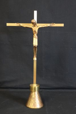 a gold crucifix with a cross on a black background