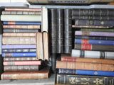 a lot of books that are stacked on top of each other