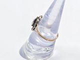 a ring that is sitting on top of a clear cone
