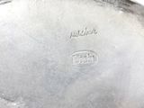 a close up of a silver plate on a table