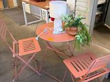 a table and chairs that are outside of a building