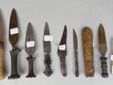 five different types of knives and a comb on the table
