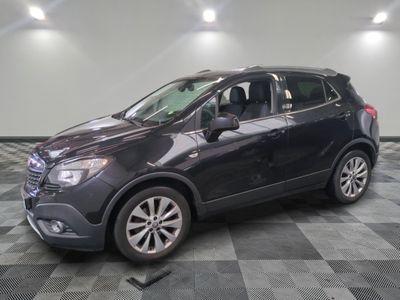 the buick suv is parked in the garage on a checkered floor