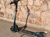 a scooter that is parked in front of a stone wall