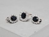 a close up of a pair of black and white diamond earrings