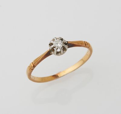 a gold and diamond ring with a single stone