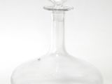 clear glass decanter with a clear base on a white surface