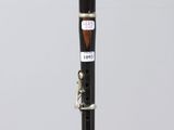 a close up of a clarinet on a clear surface with a white background