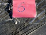 a pink piece of luggage on the ground with a sticker on it