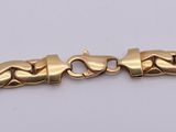 a gold bracelet with a heart design on it