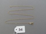 a close up of a gold chain with a tag on it