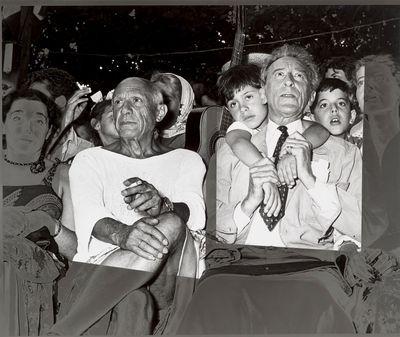 black and white photo of a group of people sitting next to each other