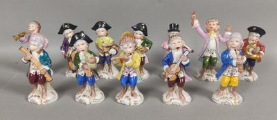seven figurines of people dressed in different colors and sizes