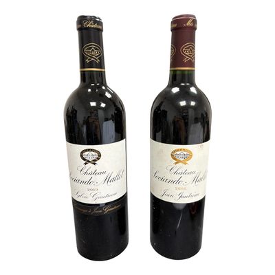 two bottles of red wine sitting next to each other on a white surface