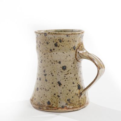 a close up of a coffee mug on a white surface