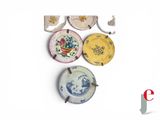 four plates with different designs on them on a white surface