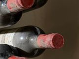 several bottles of wine are lined up on a counter