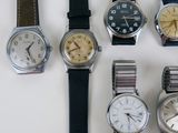 several different types of watches are displayed on a white surface