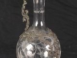 a glass vase with a handle on a black background
