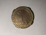 a gold coin that is sitting on top of a table