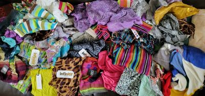 a large pile of clothing that is on a couch