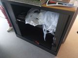a black cabinet with a bunch of items in it