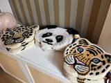 three animal rugs on a shelf in a room