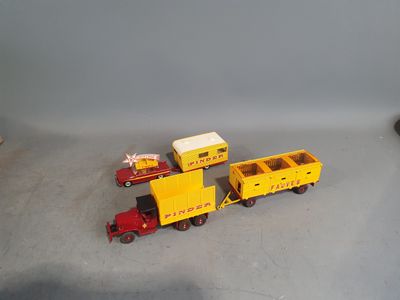 a toy train with a yellow trailer and a red truck
