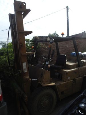 a forklift that is sitting in the back of a truck