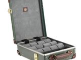 an image of a green suitcase with a bunch of watches inside of it