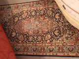 a large rug on the floor next to a dresser