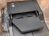 a black printer sitting on top of a plastic bag
