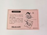 a sticker on the back of a nintendo game console