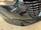 a close up of a car ' s grille with a sticker on it