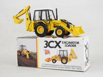 a yellow construction vehicle that is sitting on top of a box