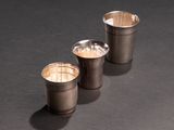 three shot glasses sitting next to each other on a table