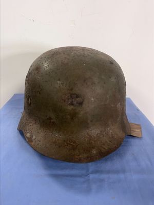 an old helmet on a blue cloth on a blue surface
