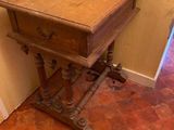 a small wooden table with a drawer on top of it