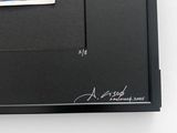 a picture of a black book with a sticker on it