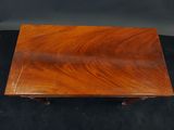 a small wooden table with two legs and a wooden top