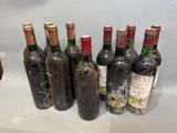 several bottles of wine are lined up in a row on a table