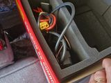 a person that is holding a box with wires in it