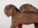 a statue of a lion and a lioness on a white background
