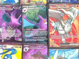 pokemon cards are lined up in a row on a table