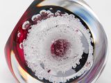 a close up of a glass object on a white surface