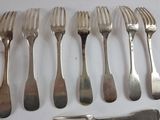a lot of forks and knives on the table