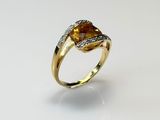 a gold ring with a citrine stone and diamonds