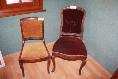 two chairs sitting next to each other in a room