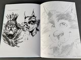 an open book with a drawing of two cats and a cat with a crown on it