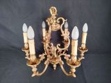 an image of a golden chandelier with five lights